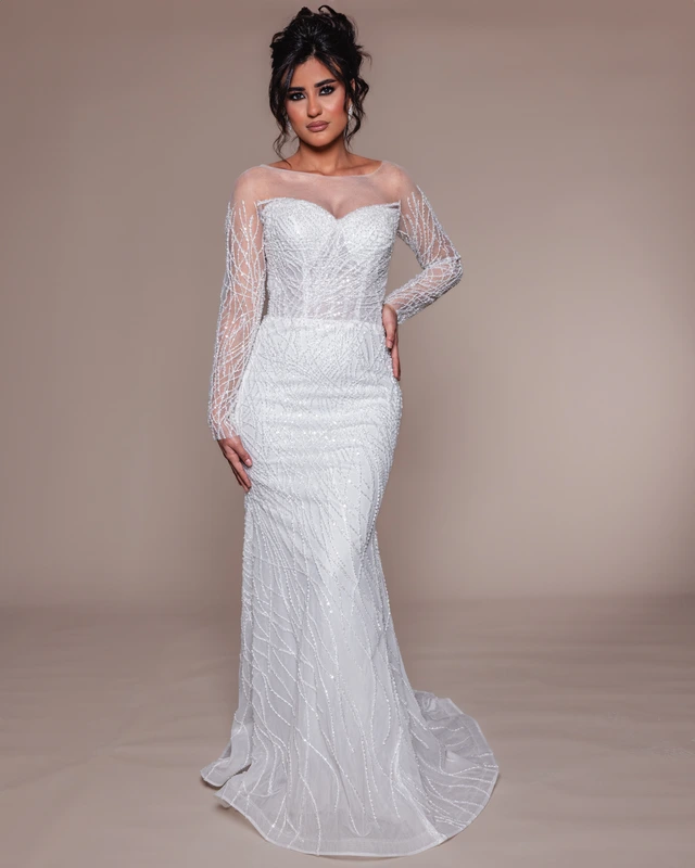 White fitted bridal gown with a sweetheart bodice and sheer, embellished long sleeves., photo 1