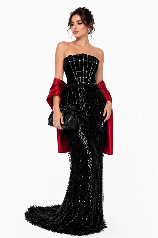 Black strapless gown with a grid-patterned bodice, paired with a red wrap., photo 1