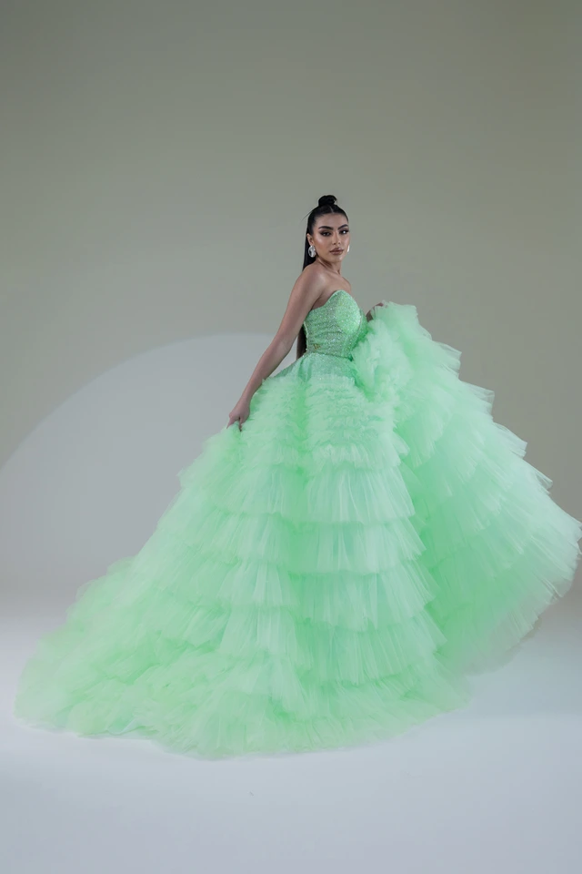 Mint-green gown with voluminous tiers of ruffles and an extended train., photo 1