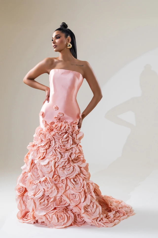 Pink strapless gown with a smooth bodice and a skirt covered in large rosette details., photo 1