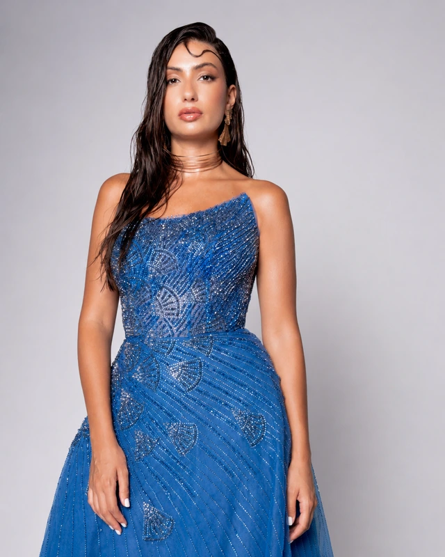 Blue gown with an asymmetric neckline and curved, shimmering decoration., photo 1