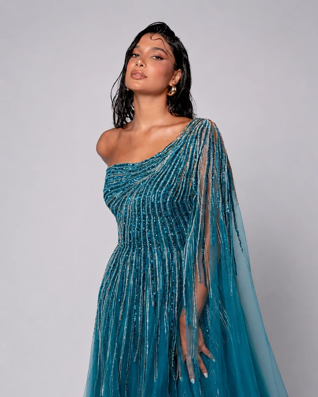 Teal one-shoulder gown with linear shimmering details and a long shoulder drape., photo 1