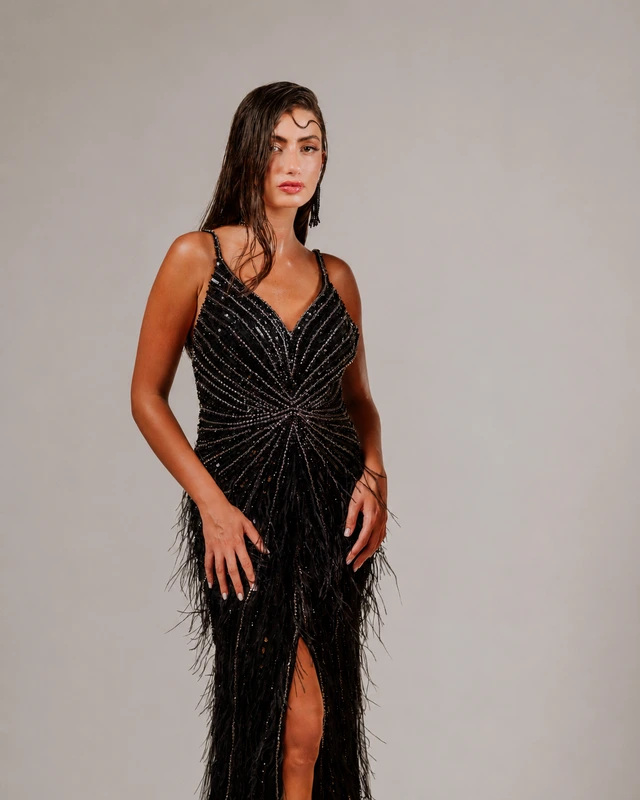 Black gown with a V neckline, radiating decorative lines and a front slit., photo 1